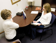 Stephanie Reid-Arndt, assistant professor of health psychology, interviews a women who was treated for cancer with chemotherapy.